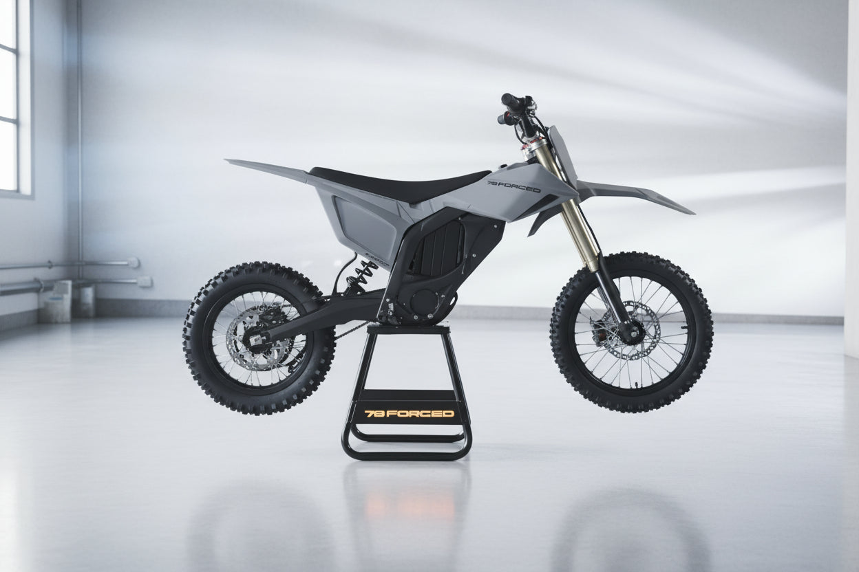 A 78 Forged electric dirt bike in matte gray and black, displayed on a black stand with orange branding in a dark studio setting. ebike moto
electric pit bike
light electric motorcycle
off road electric bike
adult electric dirt bike
high performance e-dirt bike surron alternative
talaria vs surron
Dust Moto
best electric pit bike for adults
custom electric dirt bike builds
street legal electric dirt bike
forged frame electric moto long range electric dirt
