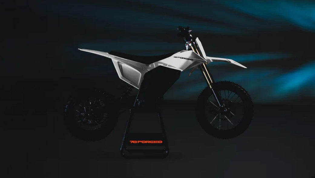 A white and black Surron Style Telaria Stark style electric dirt bike on a stand, photographed in a dark studio setting with blue light effects in the background. electric dirt bike
ebike moto
electric pit bike
light electric motorcycle
off road electric bike
adult electric dirt bike
high performance e-dirt bike surron alternative
talaria vs surron
Dust Moto
best electric pit bike for adults
custom electric dirt bike builds
street legal electric dirt bike
forged frame electric moto long range electric dirt
