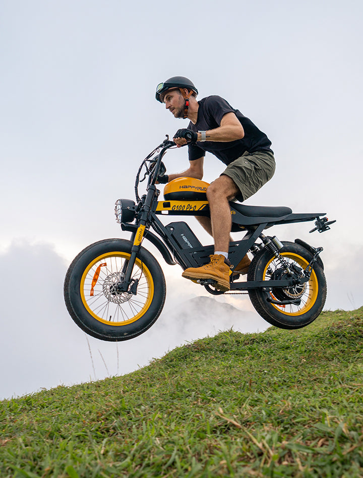 Mountain climb of yellow HappyRun G100 Pro Dual battery Electric Cargo Bikes. Off-road, all terrain E-bikes with 72V 6000W motor system, fat-tire cruisers to sleek urban commuters. NFC unlock and LED Display, Hydraulic disc drakes, Full Suspension. HappyRun G100 e-bike is similar to Freego Flash F3 Pro Max Dual Motor 750W eBike 55Ah Battery 34 MPH, Voltvogue BK-20 Adult Electric Bike, Segway Xyber Electric Bike, Freego Flash F3 Pro Max Electric Bike, Cheetah MT-380 Dual-Motor Electric Motorbike.